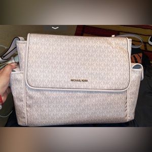 Rose gold diaper bag. Only took tags off but never used comes with changing pad